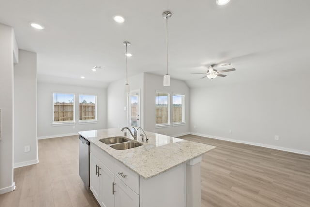 kitchen featuring a sink, white cabinetry, open floor plan, hanging light fixtures, and dishwasher