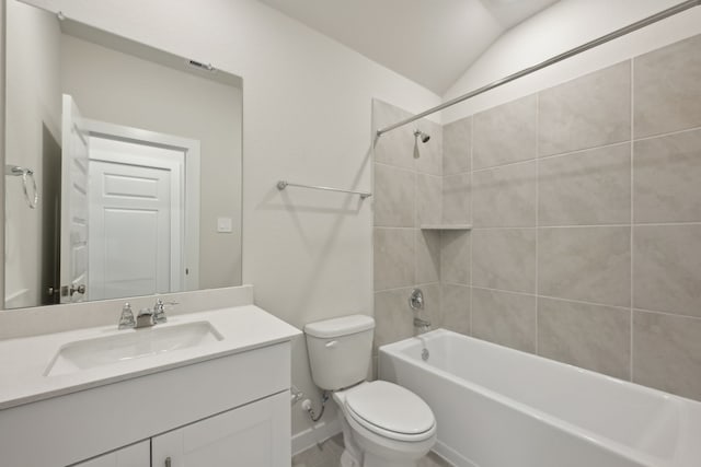 bathroom featuring toilet, lofted ceiling, tub / shower combination, and vanity