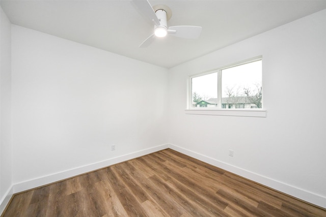 spare room with hardwood / wood-style floors and ceiling fan