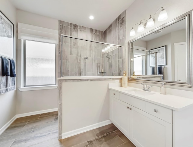 bathroom featuring vanity and tiled shower