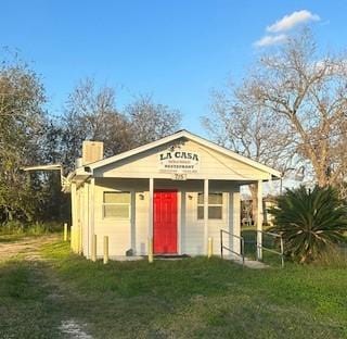 view of outbuilding featuring a lawn