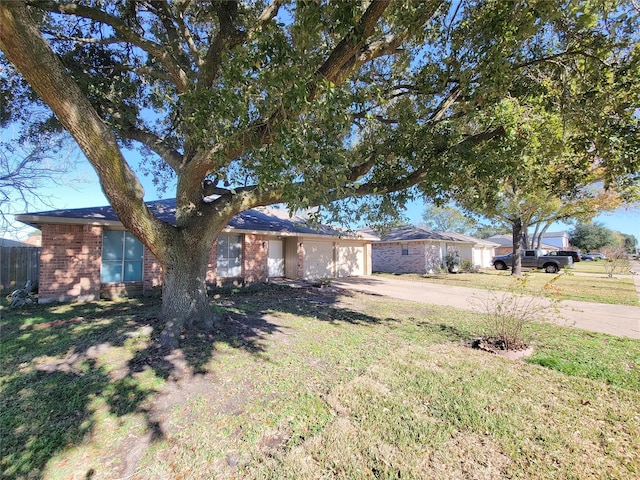 ranch-style house featuring a garage and a front yard