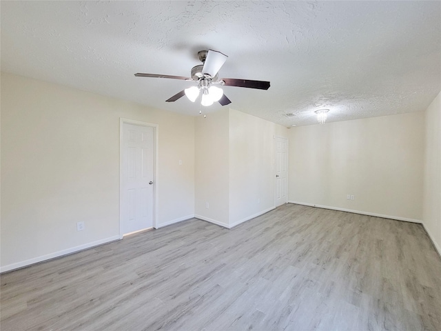 spare room with ceiling fan, light wood-type flooring, and a textured ceiling