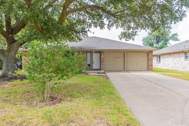 ranch-style house featuring a garage and a front yard