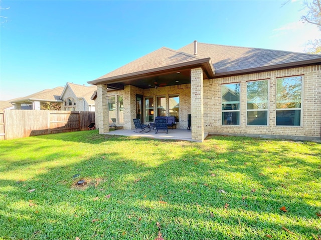 back of house with a lawn, ceiling fan, and a patio