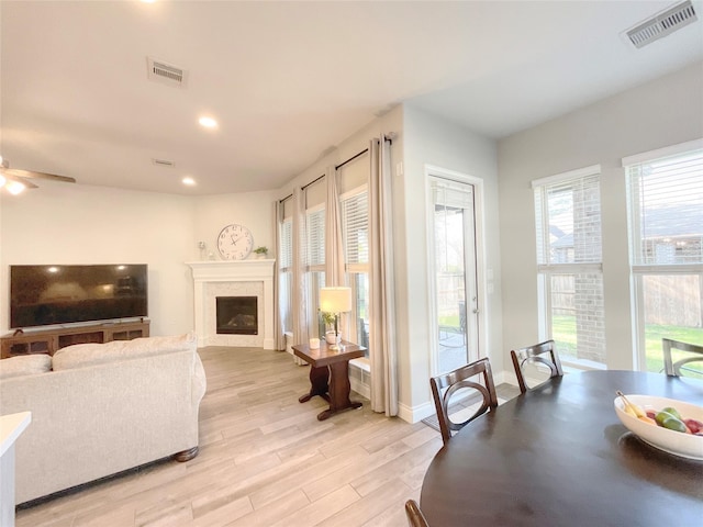 living room with ceiling fan and light wood-type flooring