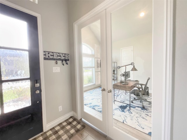 doorway with french doors and light tile patterned floors