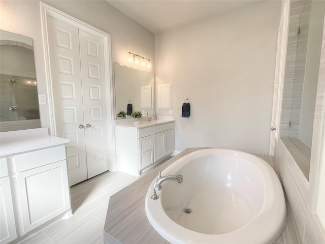 bathroom featuring tile patterned floors, vanity, and independent shower and bath