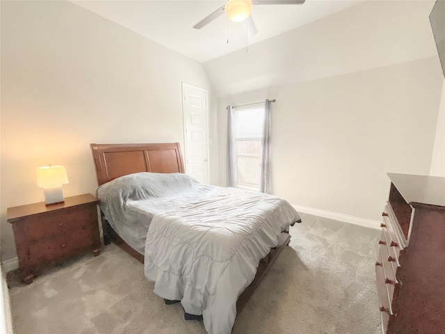 bedroom featuring ceiling fan, lofted ceiling, and light carpet