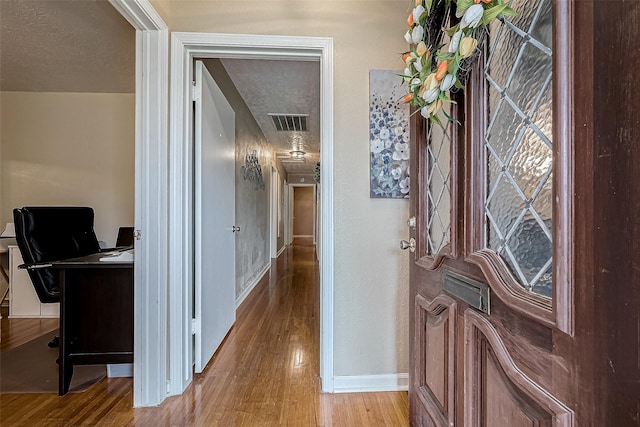 foyer featuring a textured ceiling and light hardwood / wood-style flooring