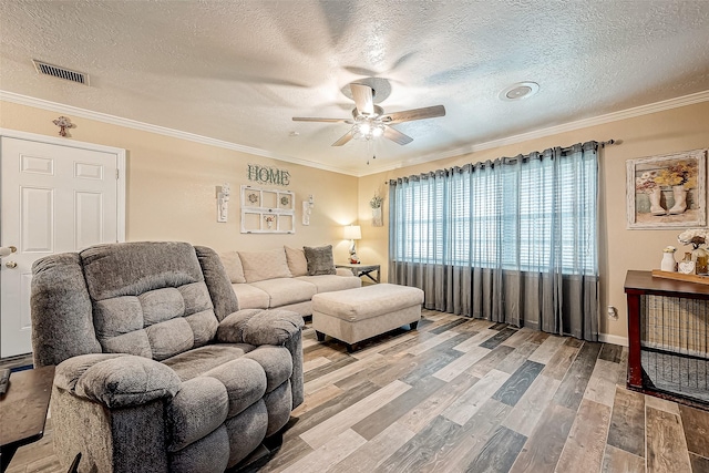 living room with crown molding, hardwood / wood-style floors, ceiling fan, and a textured ceiling