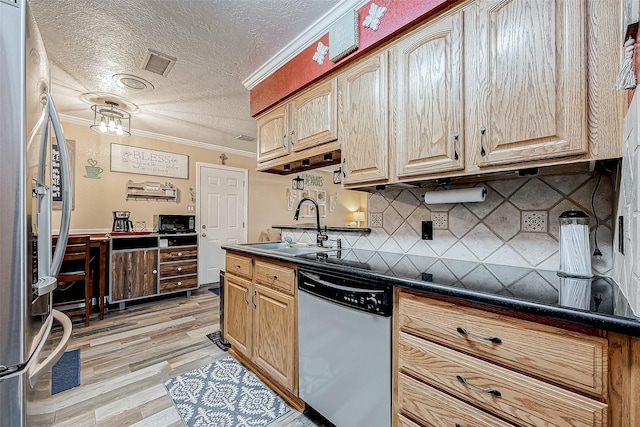 kitchen with sink, stainless steel appliances, light hardwood / wood-style flooring, crown molding, and a textured ceiling