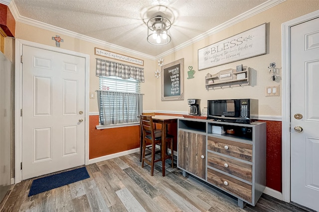 office with hardwood / wood-style floors, crown molding, and a textured ceiling