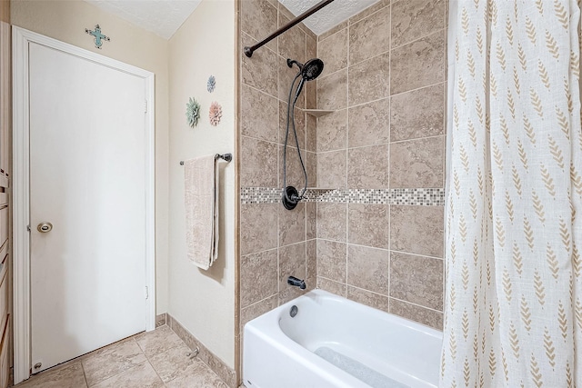 bathroom featuring tile patterned floors, a textured ceiling, and shower / tub combo with curtain