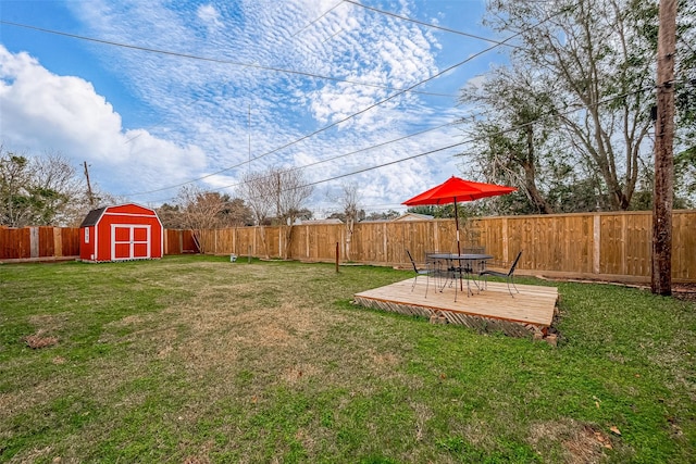 view of yard featuring a storage shed and a wooden deck