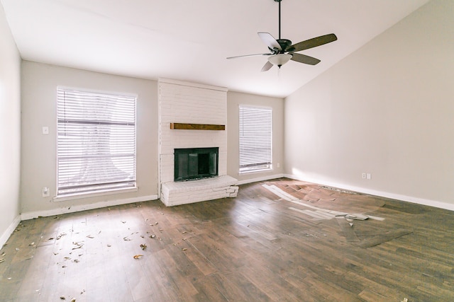 unfurnished living room with a fireplace, dark hardwood / wood-style floors, ceiling fan, and lofted ceiling