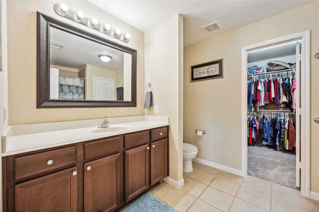 bathroom with tile patterned floors, vanity, and toilet