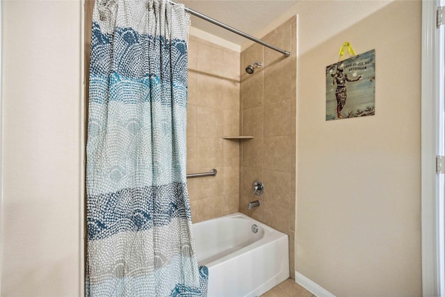 bathroom with shower / bath combo with shower curtain