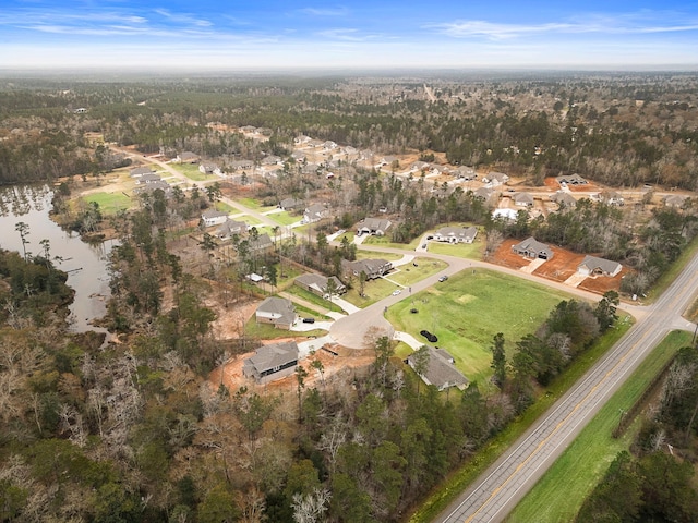 drone / aerial view featuring a water view and a residential view