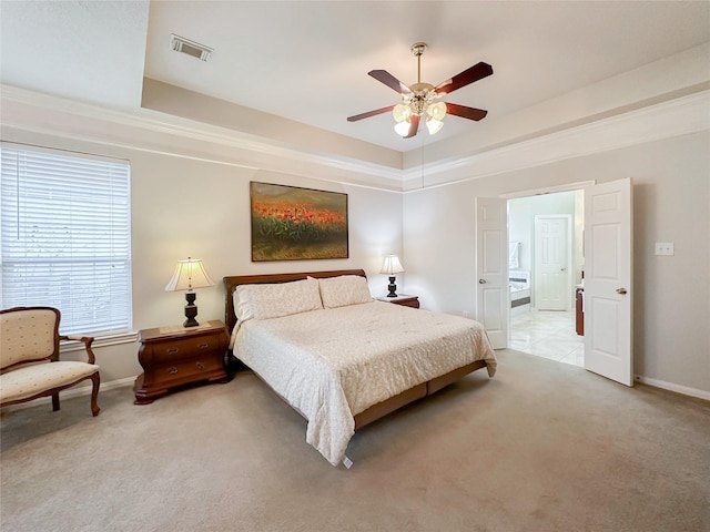 carpeted bedroom featuring a raised ceiling and ceiling fan