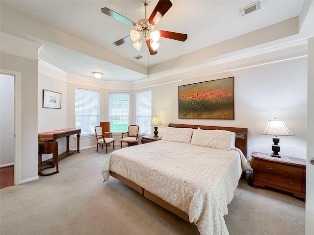 bedroom featuring ceiling fan, crown molding, and light colored carpet