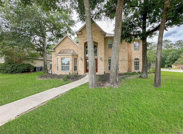 view of front of property with cooling unit and a front yard