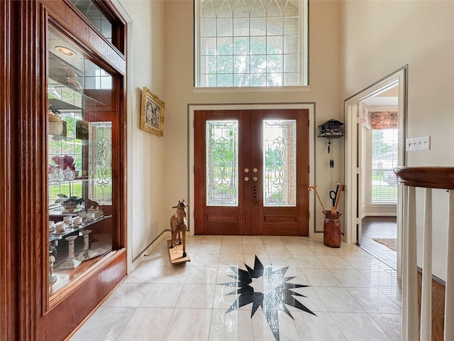 entrance foyer with french doors and a towering ceiling