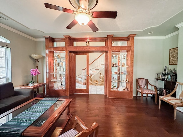 living room with ceiling fan, dark hardwood / wood-style floors, and ornamental molding