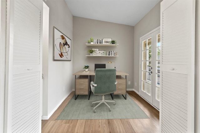 office featuring french doors, hardwood / wood-style flooring, and vaulted ceiling