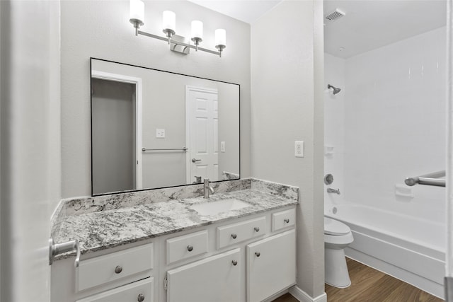 full bathroom featuring hardwood / wood-style flooring, vanity, toilet, and shower / bath combination