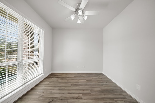 unfurnished room featuring ceiling fan and dark hardwood / wood-style floors