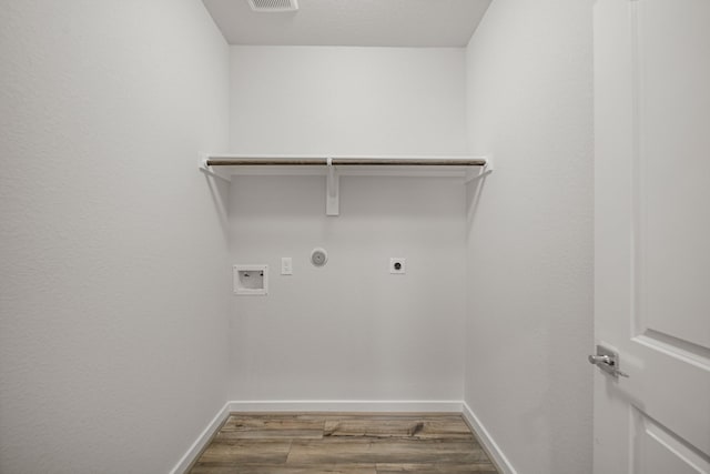 clothes washing area featuring washer hookup, hardwood / wood-style flooring, electric dryer hookup, and gas dryer hookup