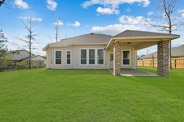 back of house featuring a patio and a lawn