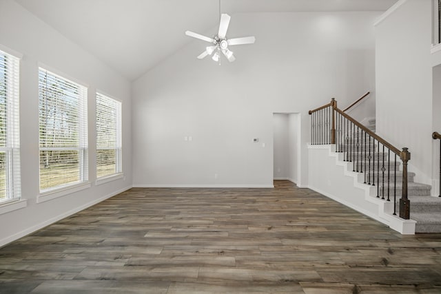 unfurnished living room featuring dark wood-type flooring, high vaulted ceiling, and ceiling fan