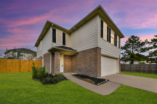 view of front of property featuring a yard and a garage