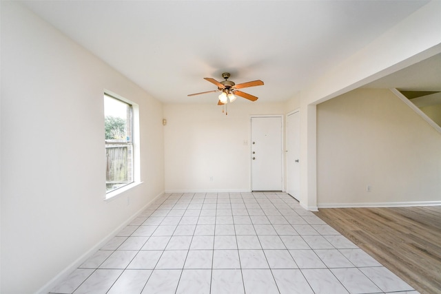 unfurnished room featuring ceiling fan and light tile patterned floors