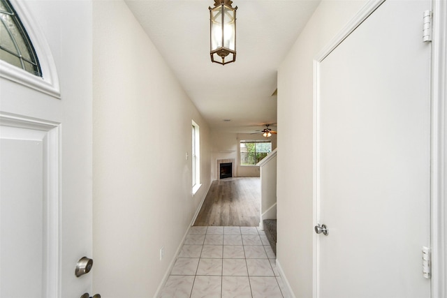 hall with light tile patterned floors