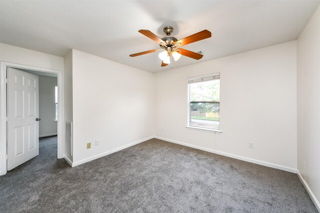 carpeted spare room with ceiling fan