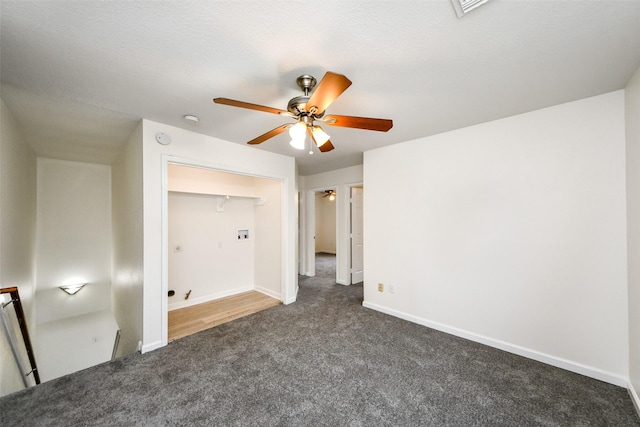 unfurnished bedroom with ceiling fan, dark carpet, and a closet