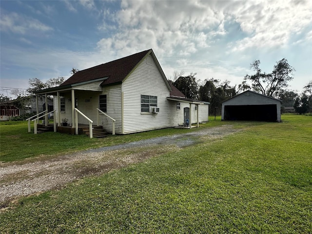 view of property exterior with cooling unit, a garage, a yard, and an outbuilding