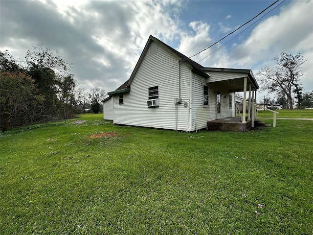 view of property exterior with a porch, cooling unit, and a lawn