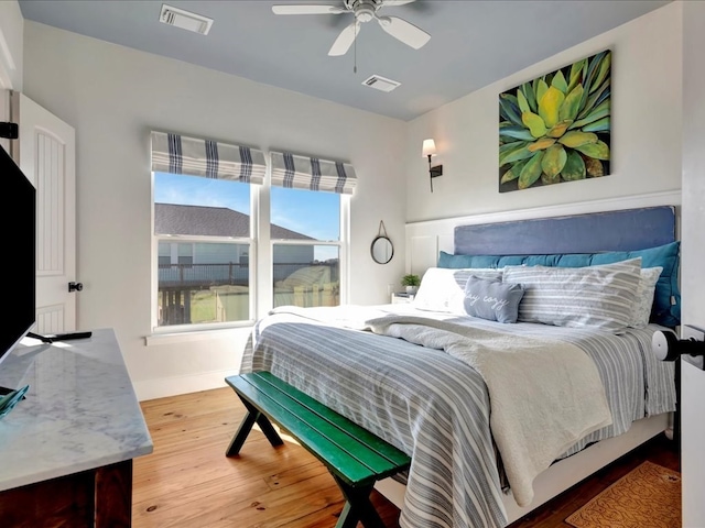 bedroom with ceiling fan and wood-type flooring