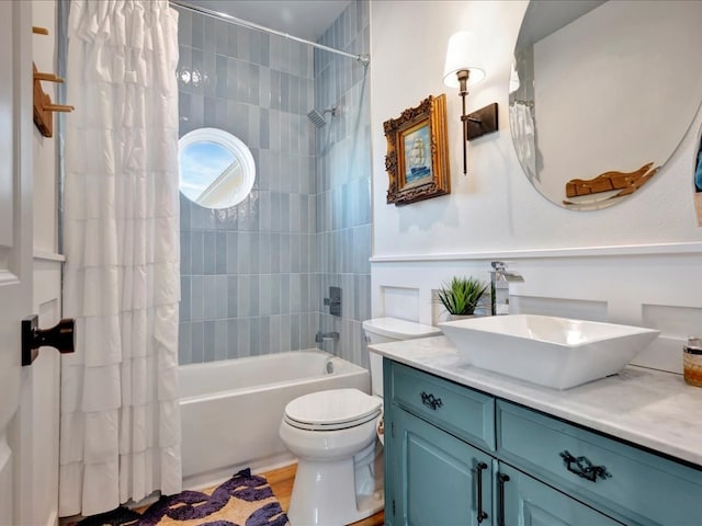 full bathroom featuring vanity, shower / tub combo, and toilet