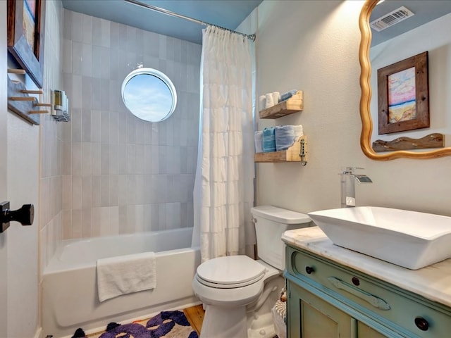 full bathroom with shower / bath combination with curtain, vanity, and toilet