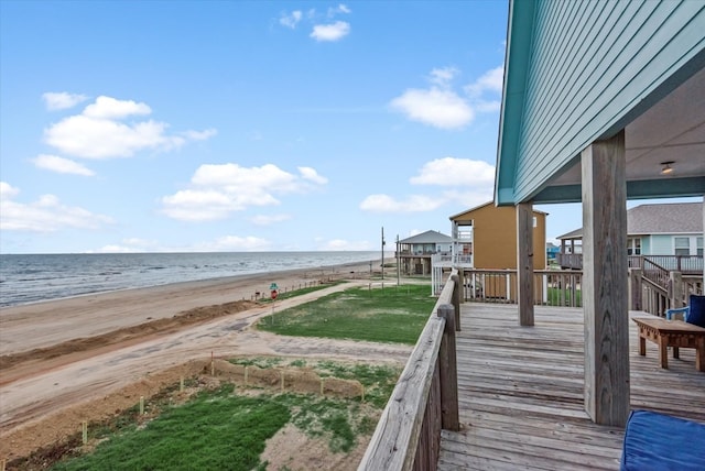 deck featuring a water view and a beach view