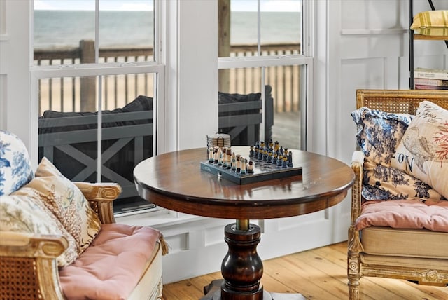 interior space with a water view and hardwood / wood-style flooring