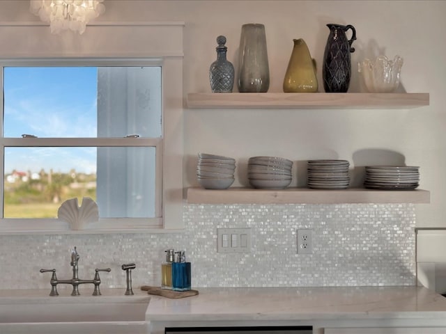 details featuring decorative backsplash and sink