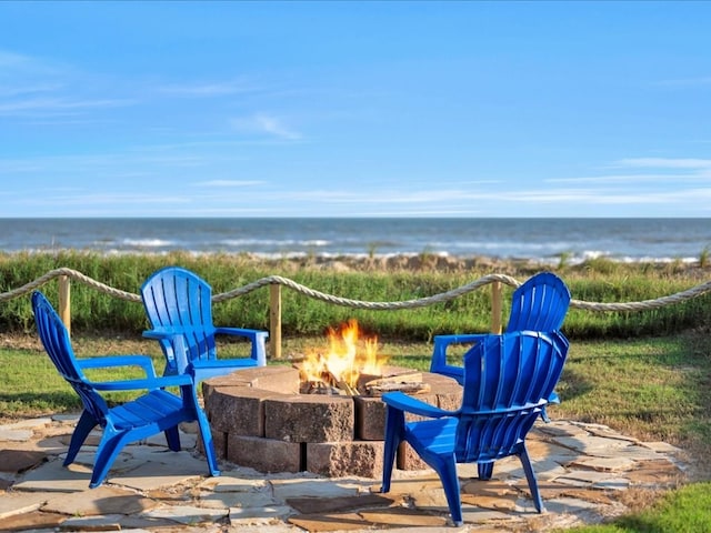 view of patio with a water view and an outdoor fire pit