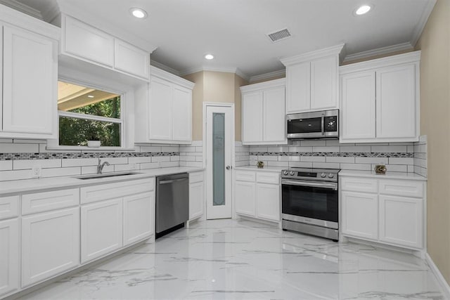 kitchen with appliances with stainless steel finishes, white cabinetry, and sink