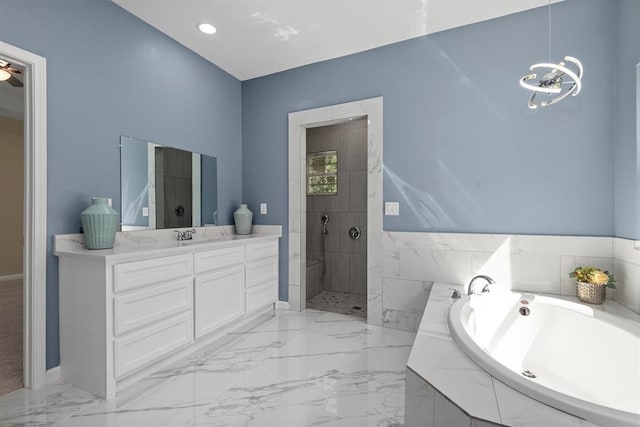 bathroom featuring vanity, independent shower and bath, and an inviting chandelier